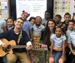 Residency - Ethan with a bunch of kids A teaching artist during our artist-in-residency program