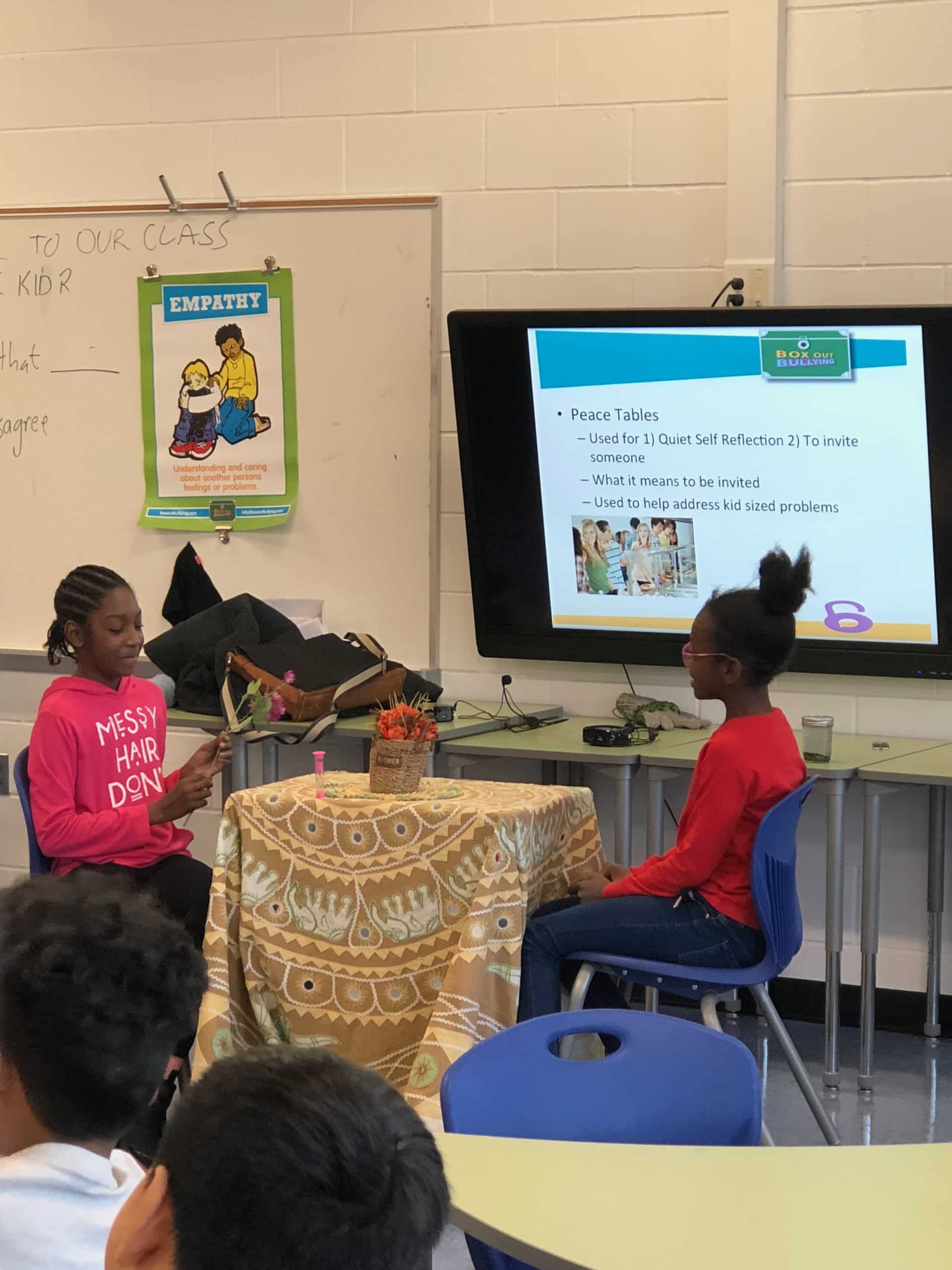 Two students talking at peace table